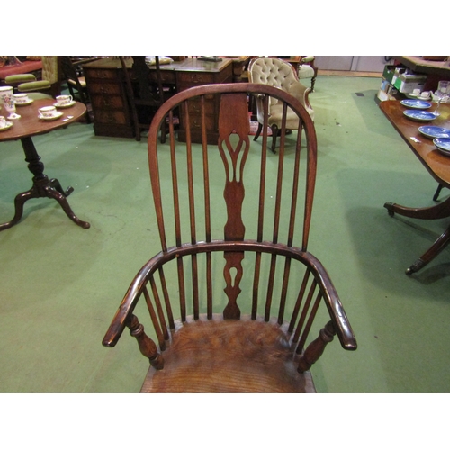 4065 - An elm seated hoop-back Windsor elbow chair, pierced splat back