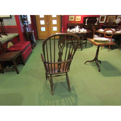 4065 - An elm seated hoop-back Windsor elbow chair, pierced splat back