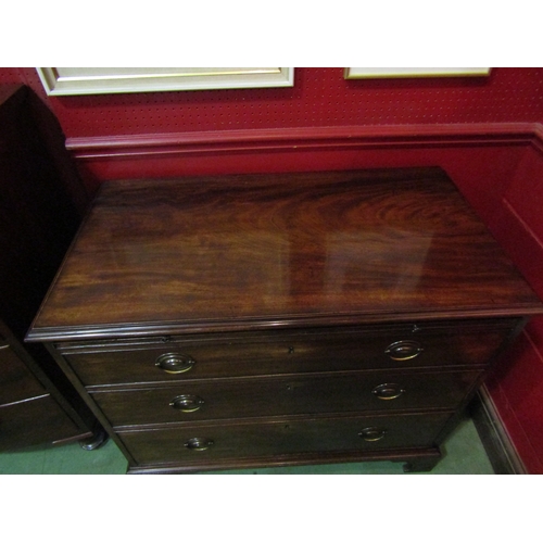 4110 - A George III flame mahogany bachelor's chest, the brushing slide over three graduating long drawers ... 