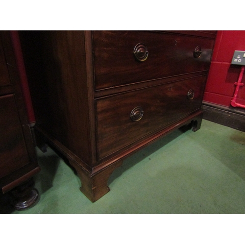 4110 - A George III flame mahogany bachelor's chest, the brushing slide over three graduating long drawers ... 