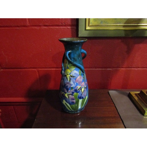 4135 - A blue glazed art pottery vase with floral design, 31cm tall