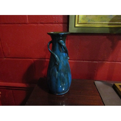 4135 - A blue glazed art pottery vase with floral design, 31cm tall