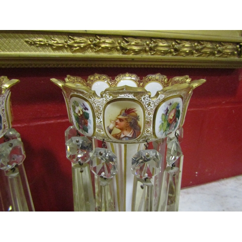 4141 - A pair of Victorian glass lustres with floral and figural panelling and droplets, 30cm tall