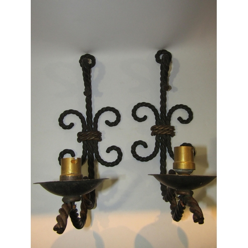 4265 - A pair of wrought-iron electric lamp sconces