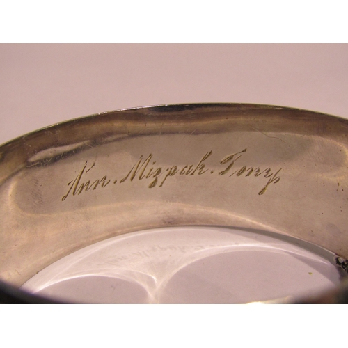 4342 - An engraved stiff hinge bangle marked Sterling