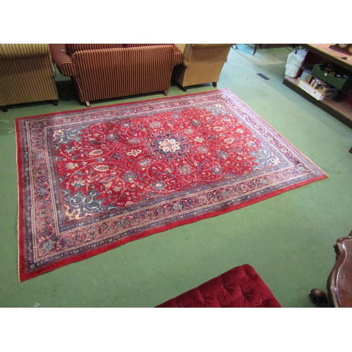 4412 - A red and blue ground wool rug with floral design and multiple borders, 3.25m x 2.23m