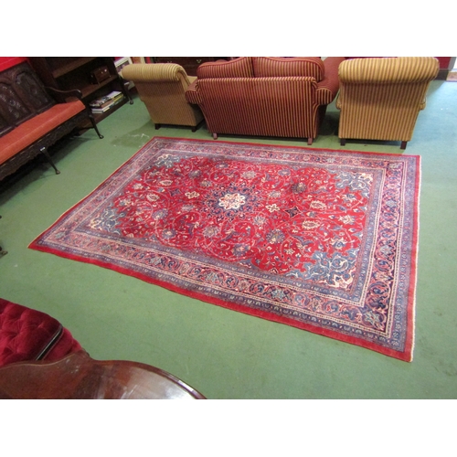 4412 - A red and blue ground wool rug with floral design and multiple borders, 3.25m x 2.23m