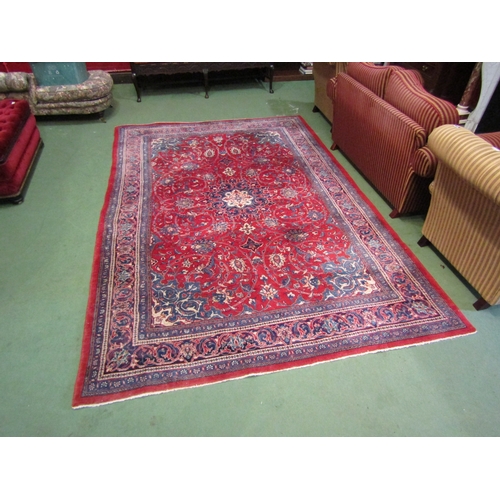 4412 - A red and blue ground wool rug with floral design and multiple borders, 3.25m x 2.23m