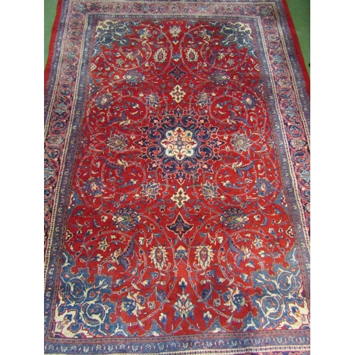 4412 - A red and blue ground wool rug with floral design and multiple borders, 3.25m x 2.23m