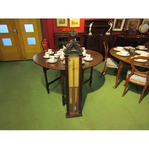 4037 - An Admiral Fitzroy barometer in Gothic style case, 128cm tall