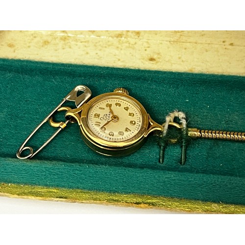 5109 - RECORD: An early 20th Century ladies 9ct gold wristwatch by Record, gold strap, Arabic dial, some da... 