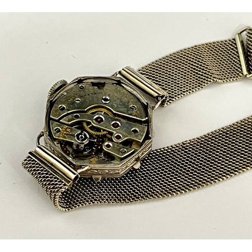 5107 - An Art Deco lady's cocktail wristwatch of octagonal form, Roman silvered dial, framed by a diamond s... 