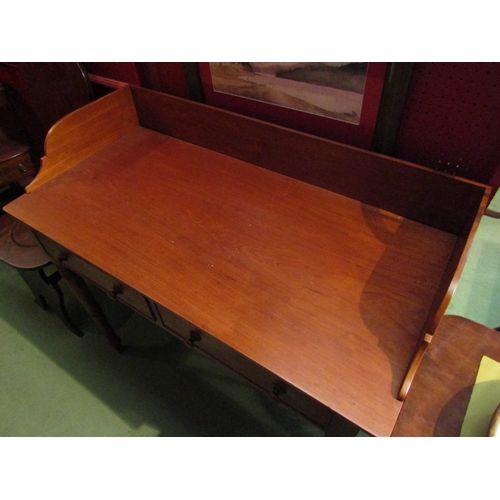 4056 - A Victorian mahogany washstand, the three quarter raised back over two frieze drawers on ring turned... 