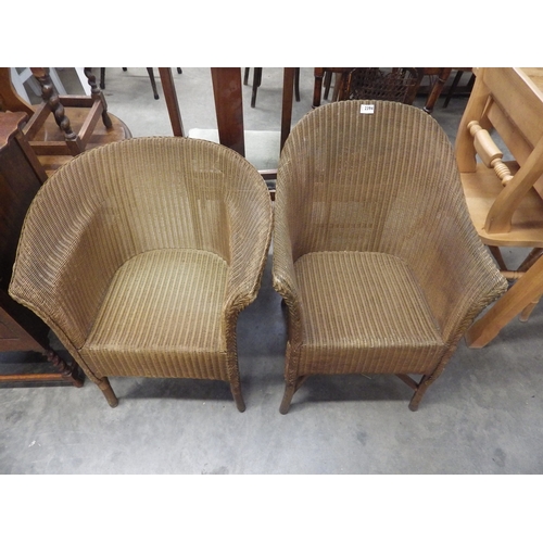 2394 - A pair of gold painted Lloyd Loom chairs