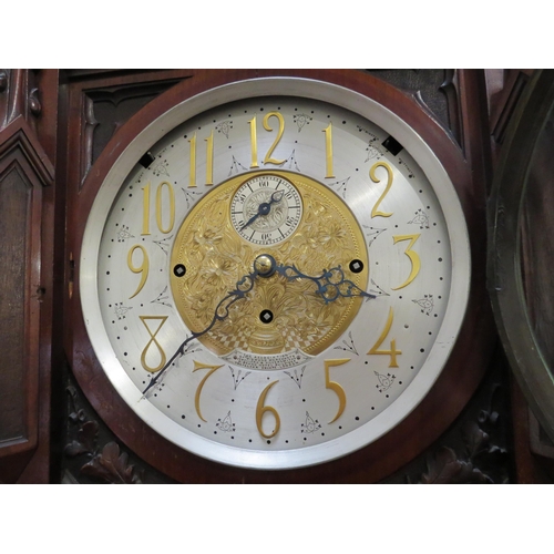 8001 - A Victorian carved oak Gothic style chiming longcase clock, attributed to J.J. Elliot. The hood with... 