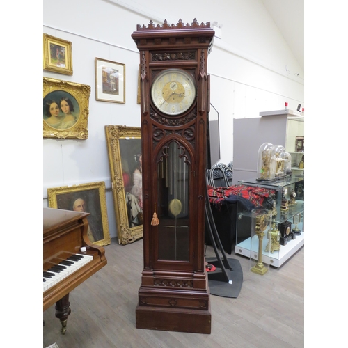 8001 - A Victorian carved oak Gothic style chiming longcase clock, attributed to J.J. Elliot. The hood with... 