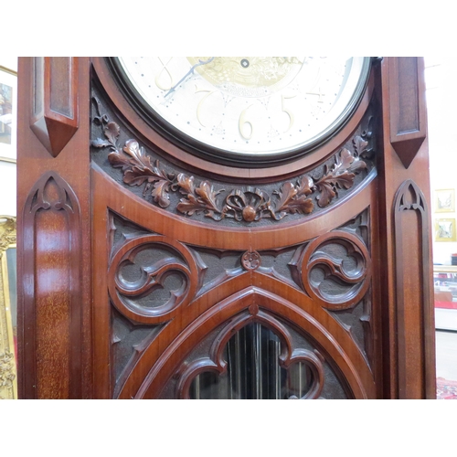 8001 - A Victorian carved oak Gothic style chiming longcase clock, attributed to J.J. Elliot. The hood with... 