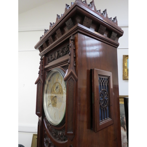 8001 - A Victorian carved oak Gothic style chiming longcase clock, attributed to J.J. Elliot. The hood with... 