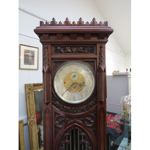 8001 - A Victorian carved oak Gothic style chiming longcase clock, attributed to J.J. Elliot. The hood with... 