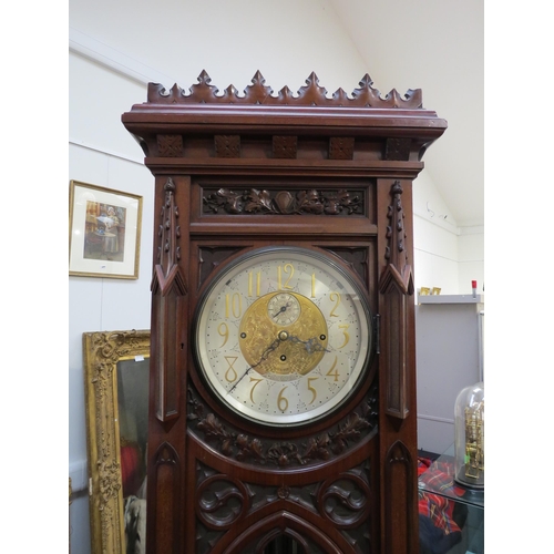 8001 - A Victorian carved oak Gothic style chiming longcase clock, attributed to J.J. Elliot. The hood with... 