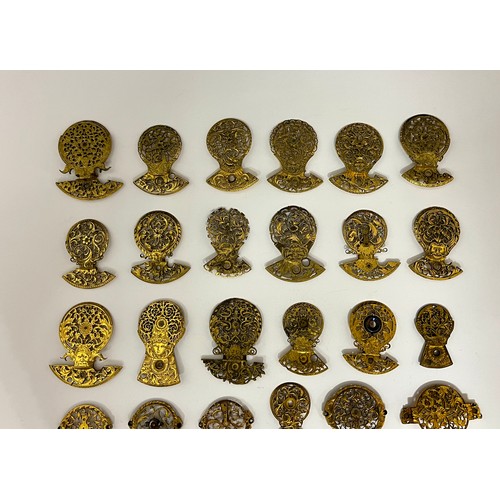 5129 - A collection of gilt metal pierced balance cocks