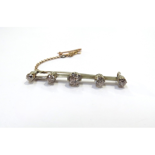 6268 - A bar brooch set with five graduated cinnamon diamonds, 0.65ct total approx, 4cm long, 3g