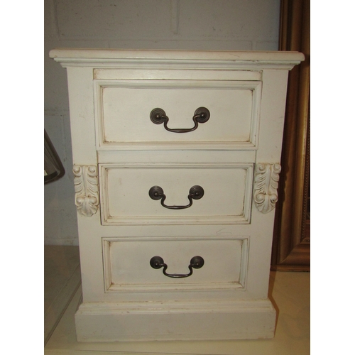 1020 - A pair of painted three drawer chests with corbel decoration over a plinth base, 62cm tall x 45cm wi... 