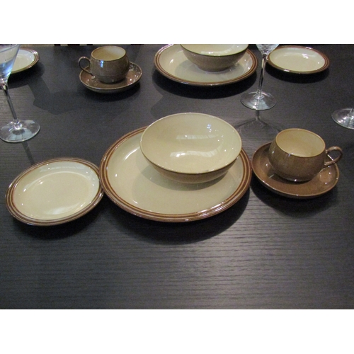 1030 - A collection of Denby stoneware dinner wares in two colour ways