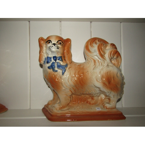 1037 - A pair of Edwardian Staffordshire pottery dogs, 23cm tall