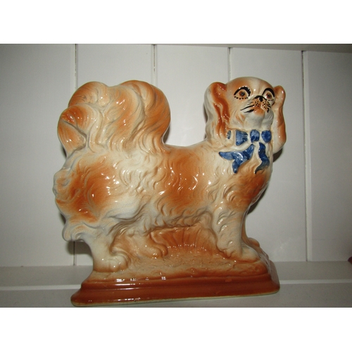 1037 - A pair of Edwardian Staffordshire pottery dogs, 23cm tall