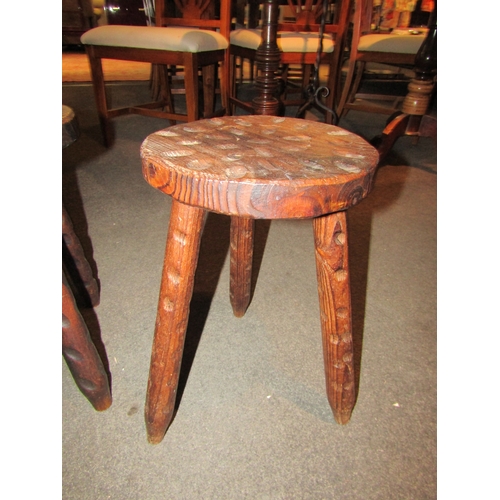 1051 - A near pair of milking stools, 44cm tall