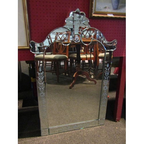 1062 - A modern Venetian style shaped top wall mirror with etched design, 89cm x 57cm