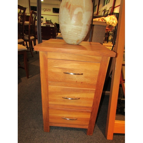 1081 - A pair of light oak bedside chests of three drawers, each 66cm tall x 42cm wide x 40cm deep, togethe... 