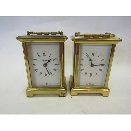 1350 - Two brass cased carriage type timepieces.  Two modern carriage timepieces.  A cream coloured plastic... 