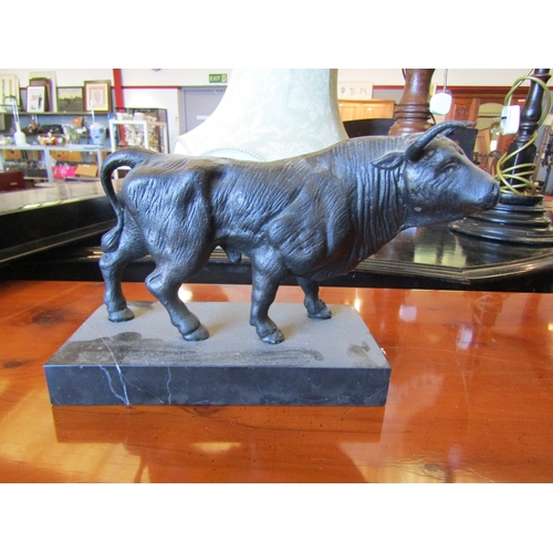 1019 - A cast model bull on marble base, 19cm tall x 29cm long