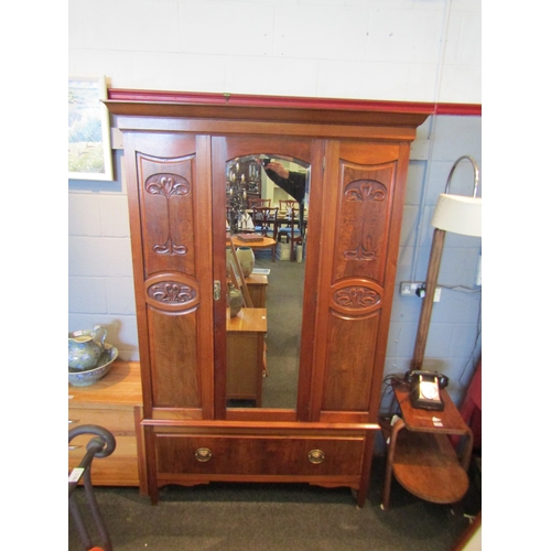 1078 - An Art Nouveau walnut wardrobe, central mirrored door, carved panels, single drawer to base, square ... 