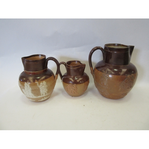 1318 - Three 19th Century Doulton stoneware commemorative jugs with relief moulded decorations, graduated