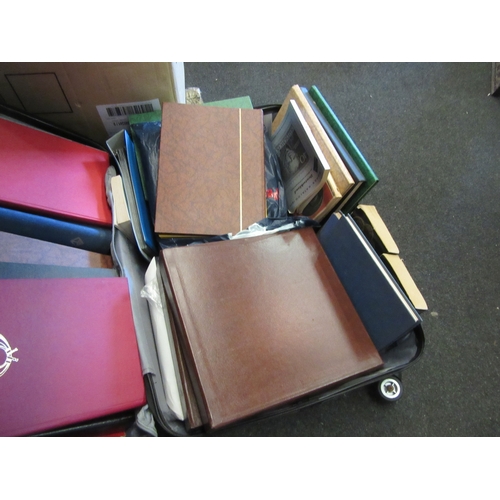 1434 - A suitcase full of stamp albums and collecting books along with coin collecting books