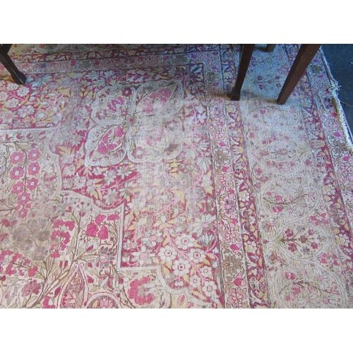 1480 - A Persian pink and cream ground rug with central floral panel, multiple borders, very worn, 380cm x ... 