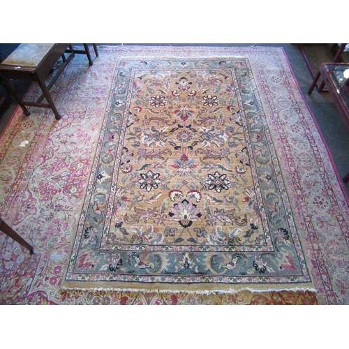 1481 - A Turkish wool rug, gold ground with green border and floral design, 246cm x 152cm