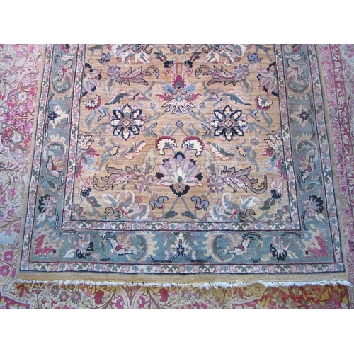 1481 - A Turkish wool rug, gold ground with green border and floral design, 246cm x 152cm