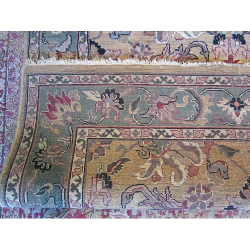 1481 - A Turkish wool rug, gold ground with green border and floral design, 246cm x 152cm