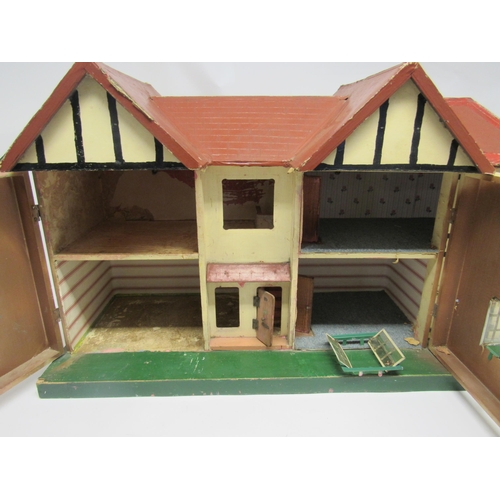 5052 - A 1950s front opening two-storey dolls house in the manner of Triang, 86cm wide x 50cm tall x 31cm d... 