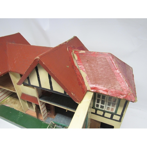 5052 - A 1950s front opening two-storey dolls house in the manner of Triang, 86cm wide x 50cm tall x 31cm d... 