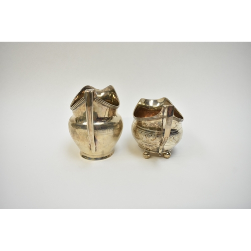 8080 - Two Georgian silver cream jugs including Thomas Wallis II 1806 with monogram to central cartouche. T... 