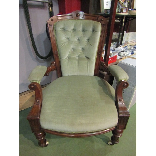 4124 - An early Victorian open armchair with sage upholstery, the button backrest and scroll arms over a bo... 