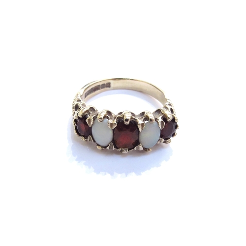 6348 - A 9ct gold five stone alternating garnet and opal ring. Size N/O, 4.3g