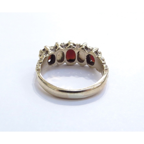 6348 - A 9ct gold five stone alternating garnet and opal ring. Size N/O, 4.3g