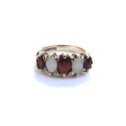 6348 - A 9ct gold five stone alternating garnet and opal ring. Size N/O, 4.3g