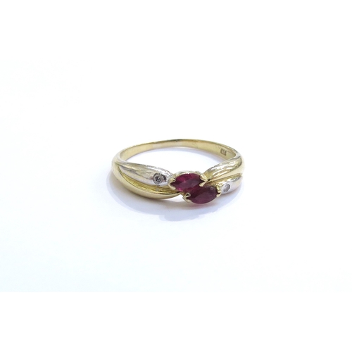 6316 - A ruby and diamond white and yellow gold crossover ring, stamped 750. Size O/P, 2.9g